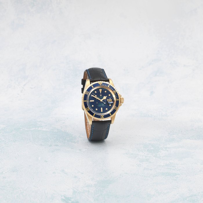 Rolex. An 18K gold automatic calendar wristwatch with tropicalised nipple dial and unusual green writing Submariner, Ref: 1680, Circa 1973