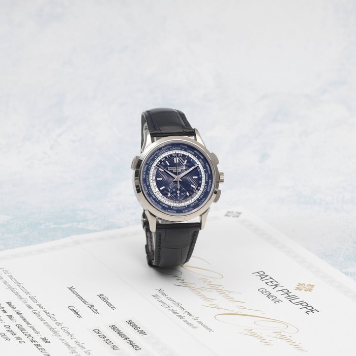 Patek Philippe. A fine 18K white gold automatic chronograph wristwatch with world time and 24-hour indication World Time, Ref: 5930G, Purchased 6th January 2017