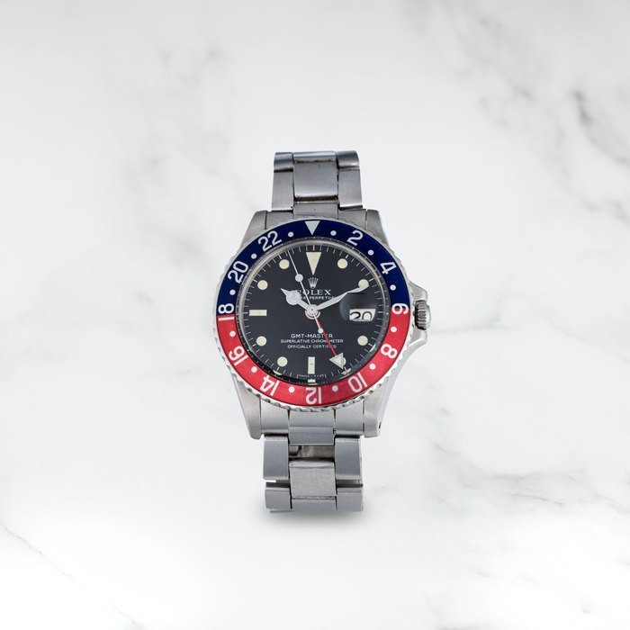 Rolex ROLEX. MONTRE BRACELET EN ACIER AVEC DATE ET 2ND FUSEAU HORAIRE MOUVEMENT AUTOMATIQUE ROLEX. A STAINLESS STEEL AUTOMATIC CALENDAR BRACELET WATCH WITH DUAL TIME ZONE GMT Master 'Pepsi', Ref: 1675, Circa 1970 · 1675