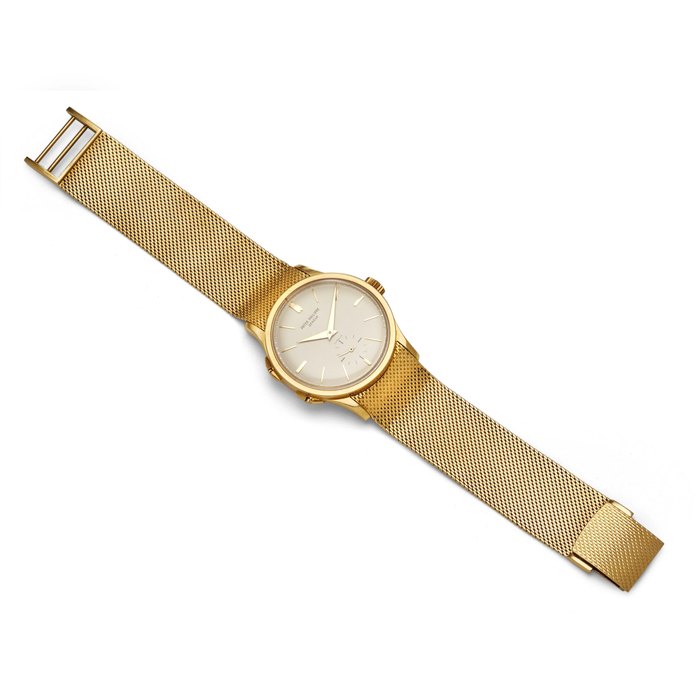 Patek Philippe. A fine and rare 18K gold dual time zone wristwatch with independently adjustable hour hand and an 18K gold braceletRetailed by Gübelin Ref: 2597, 1961
