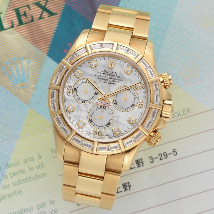 Rolex. An 18K gold and diamond set automatic chronograph bracelet watch with mother of pearl dial Daytona, Ref: 116568, Circa 2000