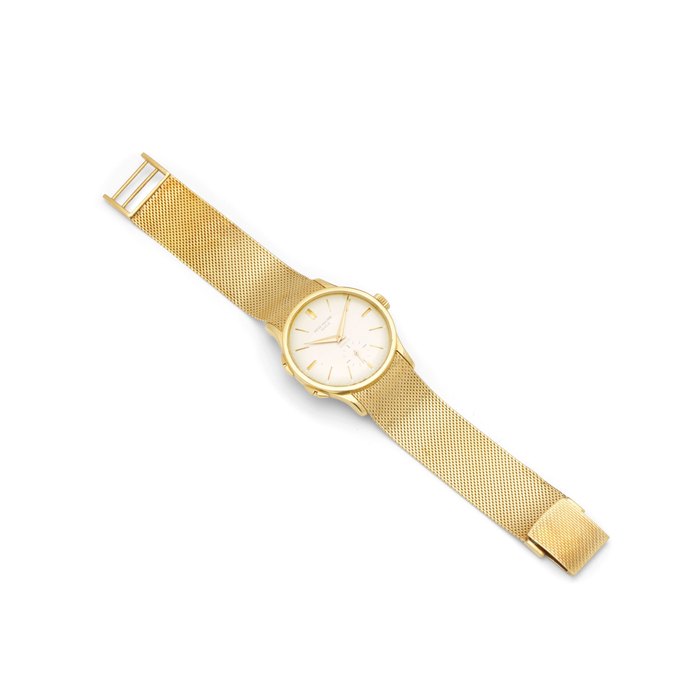 Patek Philippe. A fine and rare 18K gold dual time zone wristwatch with independently adjustable hour hand and an 18K gold braceletRetailed by Gübelin Ref: 2597, 1960