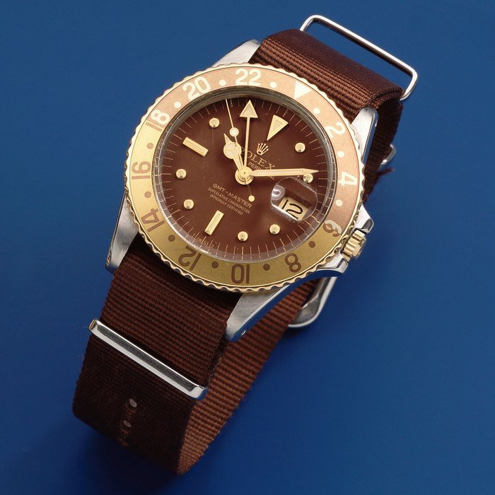 Rolex Rolex. A stainless steel and gold automatic calendar wristwatch with second time zone and 'root beer' bezel GMT Master, Ref: 1675, Circa 1972 · 1675