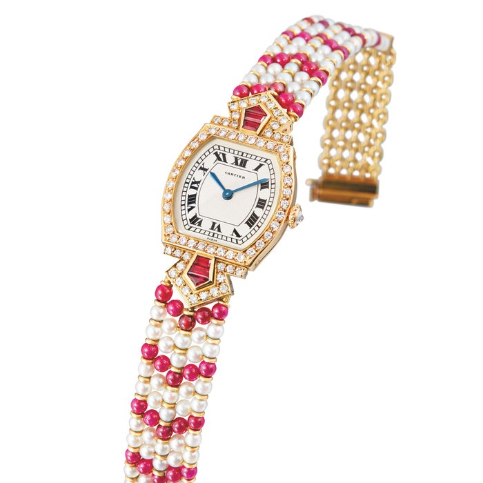Cartier, A Rare Lady's Yellow Gold, Ruby, Diamond and Pearl-Set Tonneau Bracelet Watch