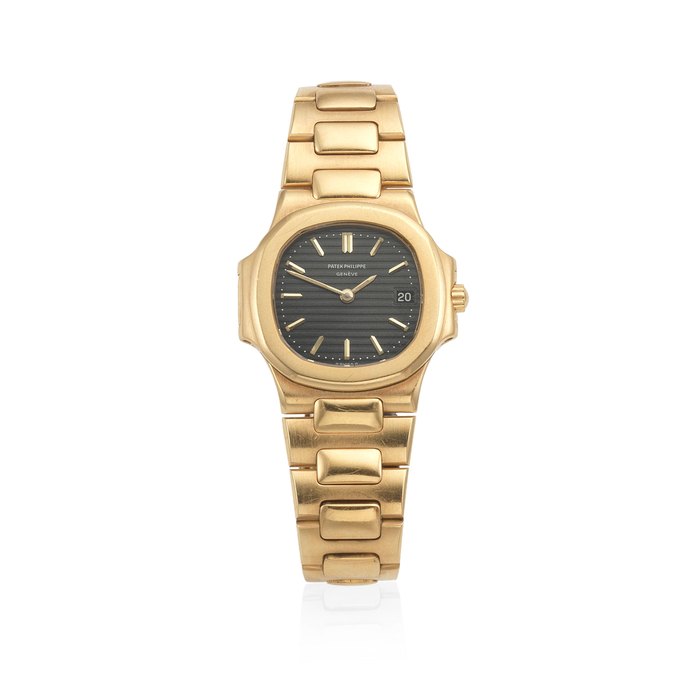 Patek Philippe. A lady's 18K gold quartz calendar bracelet watch Nautilus, Ref: 4700/1, Circa 1985