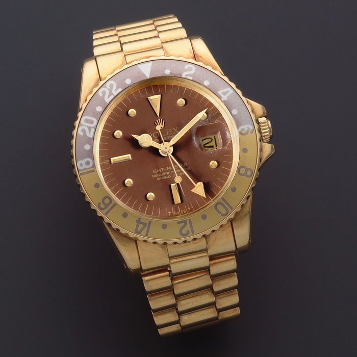Rolex Rolex. An 18K gold automatic calendar bracelet watch with dual time zone and 'root beer' bezel GMT-Master, Ref: 1675, Circa 1977 · 1675