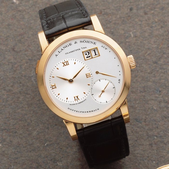 A. Lange & Söhne. An 18K gold manual wind calendar wristwatch with power reserve Lange 1, Ref: 101.032, Sold 26th July 2001