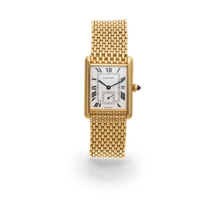 Cartier. An 18K gold mid-size quartz calendar bracelet watch Tank, Circa 1990