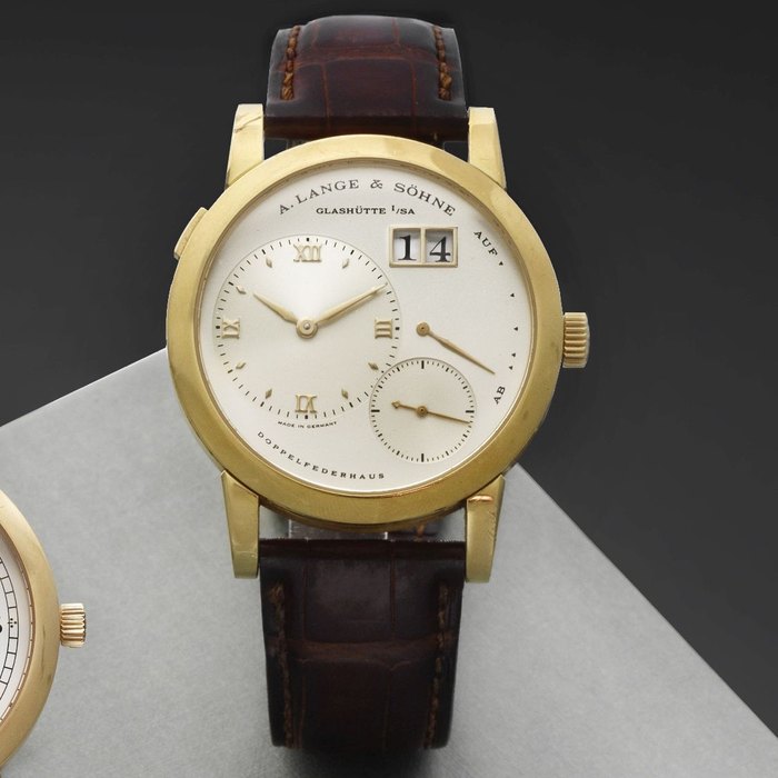 A. Lange & Söhne. An 18K gold manual wind calendar wristwatch with power reserve Lange 1, Ref:101.021, Case No.128124, Movement No.19562, Sold June 2001
