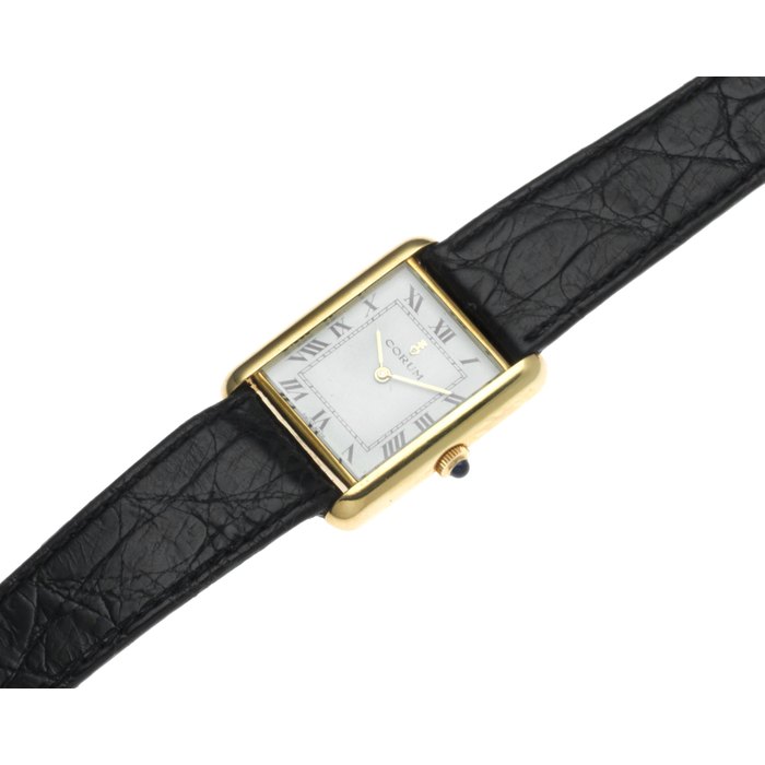 Corum. A lady's 18K gold manual wind wristwatch