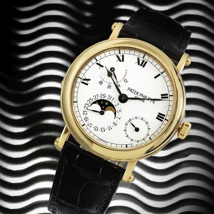 Patek Philippe. An 18K gold manual wind calendar wristwatch with moon phase and power reserve Ref:5054J, Case No.4259386, Movement No.3169987, Circa 2000