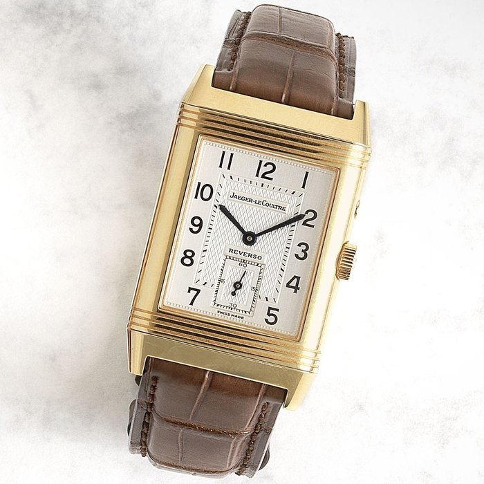 Jaeger-LeCoultre. An 18K gold rectangular manual wind dual sided reversible wristwatch Reverso Night & Day, Ref:270.254, Case No.2081716, Circa 2000