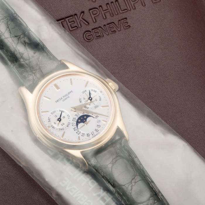 Patek Philippe. A fine 18K gold automatic perpetual calendar wristwatch with box and certificate of origin Ref:3940J, Case No.3215646, Movement No.4338235, Sold 6th February 1990