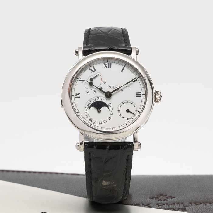 Patek Philippe. An 18K white gold automatic calendar power reserve moon phase wristwatch with certificate of origin Ref:5054G, Case No.4097299, Movement No.3112798, Sold 9th September 2000
