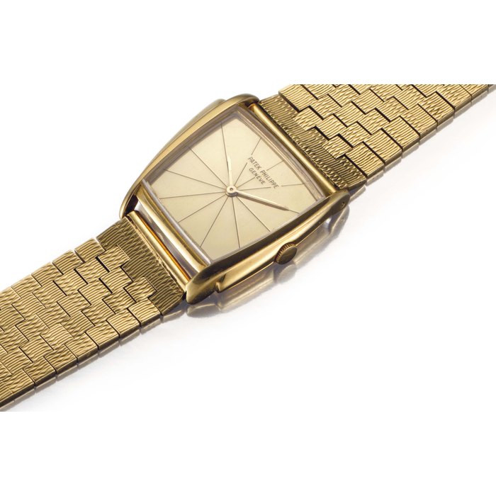 Patek Philippe. An 18k Gold Asymmetrical Wristwatch with Champagne Dial and Bracelet, Designed by Gilbert Albert and Retailed by Serpico Y Laino Signed Patek Philippe, Genève, Retailed by Serpico Y Laino, Ref. 3422, Movement No. 861'488, Case No. 2'626'924, Manufactured in 1962
