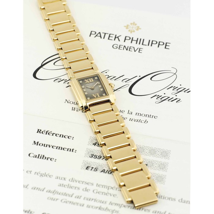 PATEK PHILIPPE. A LADY'S 18K GOLD AND DIAMOND-SET RECTANGULAR WRISTWATCH WITH BRACELET SIGNED PATEK PHILIPPE, GENEVE, TWENTY-4 MODEL, REF. 4907, MOVEMENT NO. 3597306, CASE NO. 4483798, MANUFACTURED IN 2012