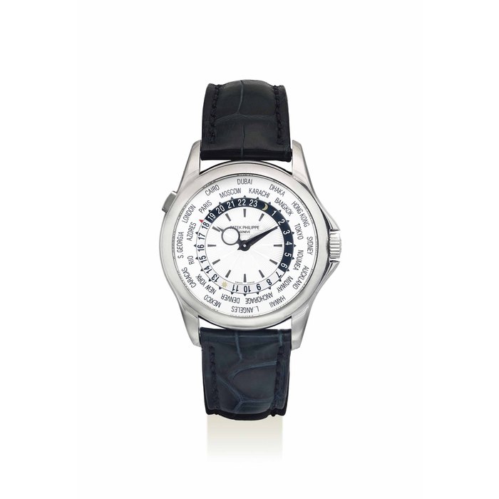 PATEK PHILIPPE. A FINE 18K WHITE GOLD AUTOMATIC WORLD TIME WRISTWATCH SIGNED PATEK PHILIPPE, GENEVE, REF. 5130G-001, MOVEMENT NO. 3'671'073, CASE NO. 4'453'227, CIRCA 2009