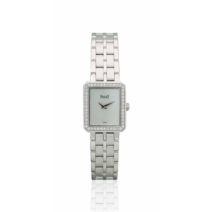 PIAGET. A LADY'S 18K WHITE GOLD AND DIAMOND-SET RECTANGULAR WRISTWATCH WITH BRACELET AND MOTHER-OF-PEARL DIAL SIGNED PIAGET, PROTOCOLE MODEL, REF. 5355 M601D, CASE NO. 808'630, CIRCA 2004