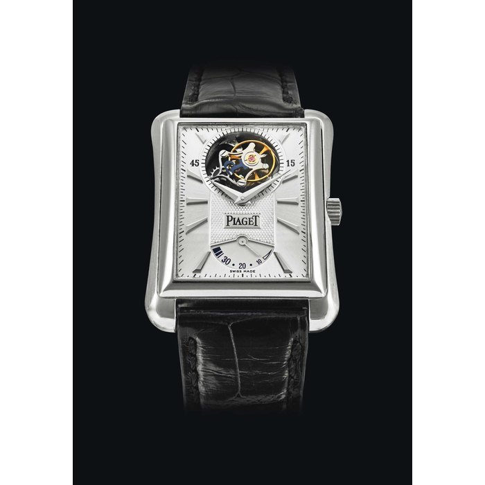 PIAGET. AN 18K WHITE GOLD RECTANGULAR TOURBILLON WRISTWATCH WITH POWER RESERVE SIGNED PIAGET, BLACK TIE EMPERADOR MODEL, REF. P10106, MOVEMENT NO. 02, CIRCA 2010