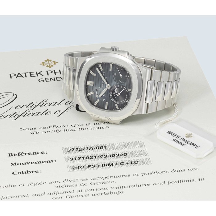 PATEK PHILIPPE. A STAINLESS STEEL AUTOMATIC WRISTWATCH WITH DATE, MOON PHASES, POWER RESERVE, BRACELET, CERTIFICATE AND BOX SIGNED PATEK PHILIPPE, GENEVE, NAUTILUS MODEL, REF. 3712/1A, MOVEMENT NO. 3'171'021, CASE NO. 4'330'320, MANUFACTURED IN 2005