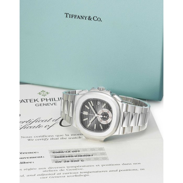 PATEK PHILIPPE. A STAINLESS STEEL AUTOMATIC CHRONOGRAPH WRISTWATCH WITH DATE, BRACELET, ORIGINAL CERTIFICATE AND BOX SIGNED PATEK PHILIPPE, GENEVE, NAUTILUS MODEL, RETAILED BY TIFFANY & CO., REF. 5980/1A, MOVEMENT NO. 3'668'349, CASE NO. 4'384'081, MANUFACTURED IN 2008