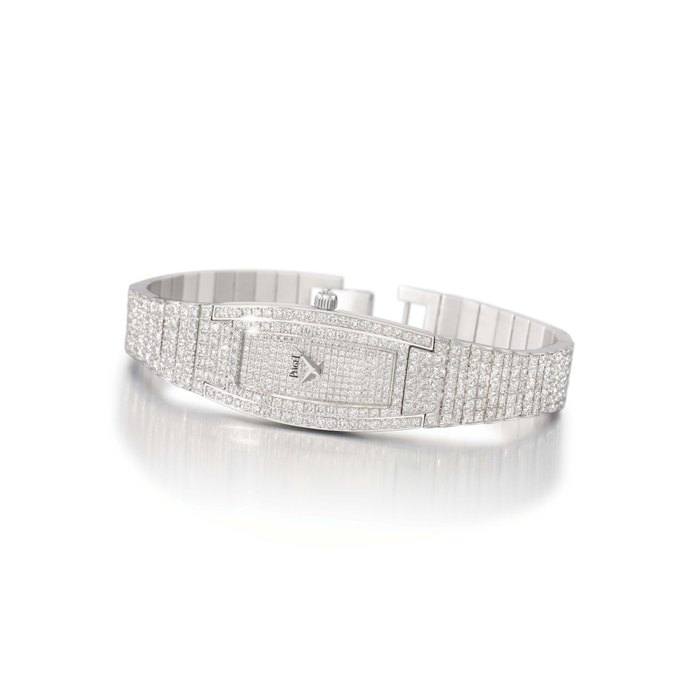 Piaget. A lady's elegant 18K white gold and diamond-set tonneau-shaped curved wristwatch with bracelet SIGNED PIAGET, LIMELIGHT MODEL, REF. 54035, CASE NO. 862'982, MANUFACTURED IN 2001