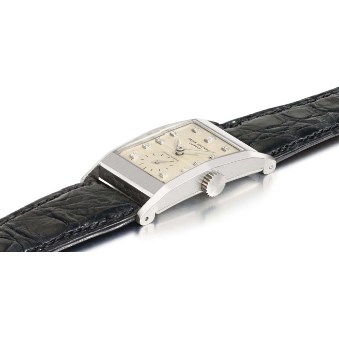 Patek Philippe. A fine and rare platinum and diamond-set rectangular curved wristwatch SIGNED PATEK PHILIPPE, GENÈVE, RETAILED BY CUERVO Y SOBRINOS, REF. 2461, MOVEMENT NO. 976'104, CASE NO. 685'011, MANUFACTURED IN 1954