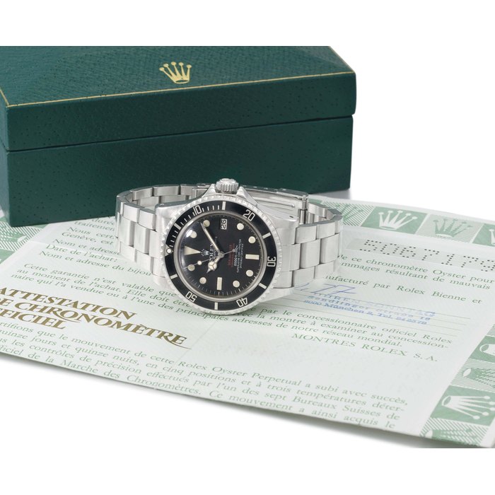 Rolex. A rare stainless steel automatic wristwatch with sweep centre seconds, date, gas escape valve, bracelet, original Guarantee and box SIGNED ROLEX, OYSTER PERPETUAL DATE, SEA-DWELLER, SUBMARINER 2000, 2000FT=610M, SUPERLATIVE CHRONOMETER OFFICIALLY CERTIFIED, "DOUBLE RED" MODEL, REF. 1665, CASE NO. 5'067'179, MANUFACTURED IN 1976