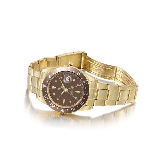 Rolex. A fine and rare 18K gold automatic dual time wristwatch with sweep centre seconds, date, bracelet and transitional case without crown guards SIGNED ROLEX, OYSTER PERPETUAL, GMT-MASTER, SUPERLATIVE CHRONOMETER OFFICIALLY CERTIFIED, REF. 1675, CASE NO. 884'275, CIRCA 1963