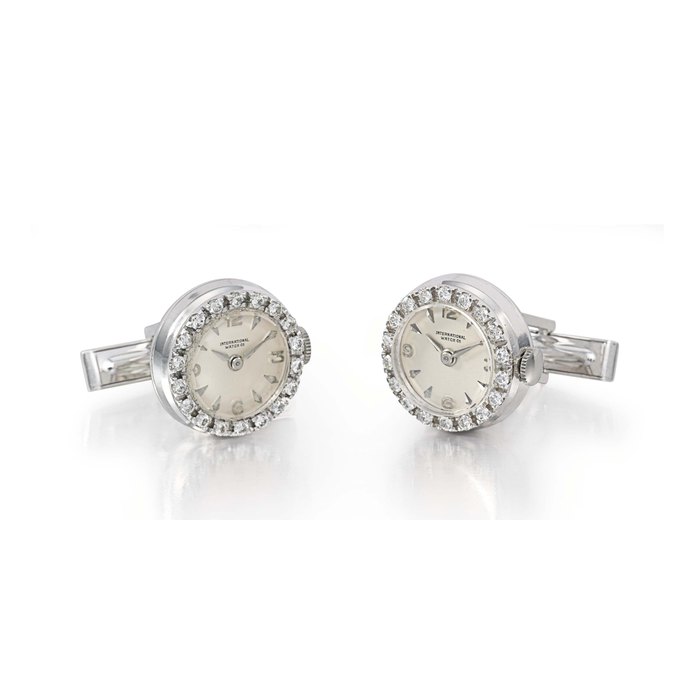 A pair of 18K white gold and diamond-set cufflinks set with watches by IWC UNSIGNED, THE WATCH MOVEMENTS AND DIALS SIGNED INTERNATIONAL WATCH CO., NOS. 1570467 AND 1570468, CIRCA 1961