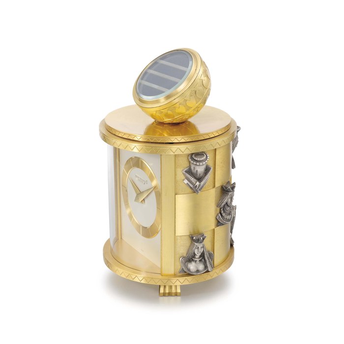 Patek Philippe. A very fine and unusual solar-powered and electro-mechanical gilt brass table clock with applied silvered chess pieces on a chessboard-pattern case and red box SIGNED PATEK PHILIPPE, GENEVE, MOVEMENT NO. 872'722, CASE NO. 228, CIRCA 1959