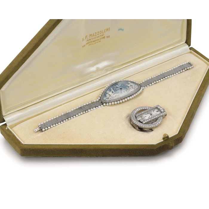 Verger Frères and Goldsmiths & Silversmiths Co. Ltd. A fine and elegant set comprising a platinum and pearl-set oval-shaped curved wristwatch with bracelet and dial painted by Paillet, and an Art Deco platinum and diamond-set clip watch, all in fitted box SIGNED VERGER FRÈRES AND PAILLET, CIRCA 1900, AND GOLDSMITHS & SILVERSMITHS CO. LTD., CIRCA 1920