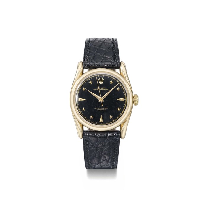 Rolex. A very rare 14K gold automatic wristwatch with sweep centre seconds, fancy lugs, black lacquer dial and star numerals SIGNED ROLEX, OYSTER PERPETUAL, REF. 6090, MOVEMENT NO. 18'709, CIRCA 1955