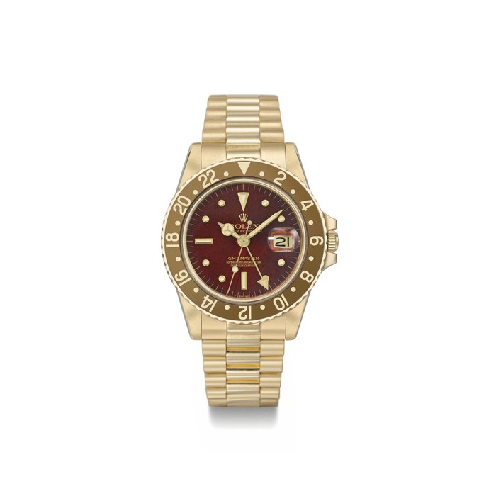 Rolex. An 18K gold automatic dual time zone wristwatch with sweep centre seconds, date, brown dial and bezel, as well as bracelet SIGNED ROLEX, OYSTER PERPETUAL, GMT-MASTER, REF. 1675, CASE NO. 5'995'940, MANUFACTURED IN 1980