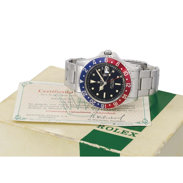 Rolex. A rare stainless steel automatic dual time wristwatch with sweep centre seconds, date, black lacquered dial, bracelet and pointed crown guards, original Guarantee and box SIGNED ROLEX, OYSTER-PERPETUAL, GMT-MASTER, OFFICIALLY CERTIFIED CHRONOMETER, REF. 1675, CASE NO. 504'295, CIRCA 1959