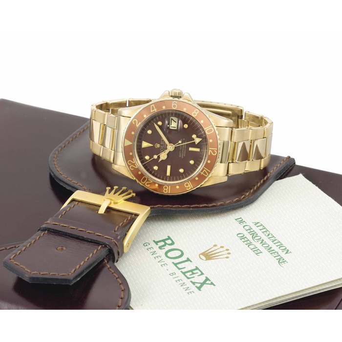 Rolex. A fine and rare 18K gold automatic dual time wristwatch with sweep centre seconds, date, bracelet and original guarantee and box SIGNED ROLEX, OYSTER PERPETUAL, GMT-MASTER, REF. 1675, CASE NO. 2'605'658, CIRCA 1970