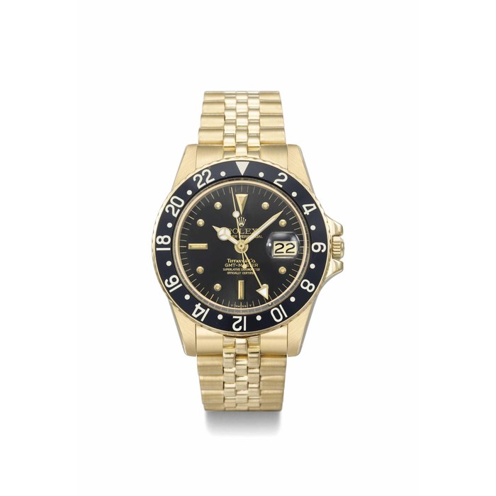 Rolex. A very fine, rare and attractive 18K gold automatic dual time wristwatch with sweep centre seconds, date and bracelet SIGNED ROLEX, OYSTER PERPETUAL, GMT-MASTER, RETAILED BY TIFFANY & CO, REF. 1675, CASE NO. 5'879'611, MANUFACTURED IN 1980