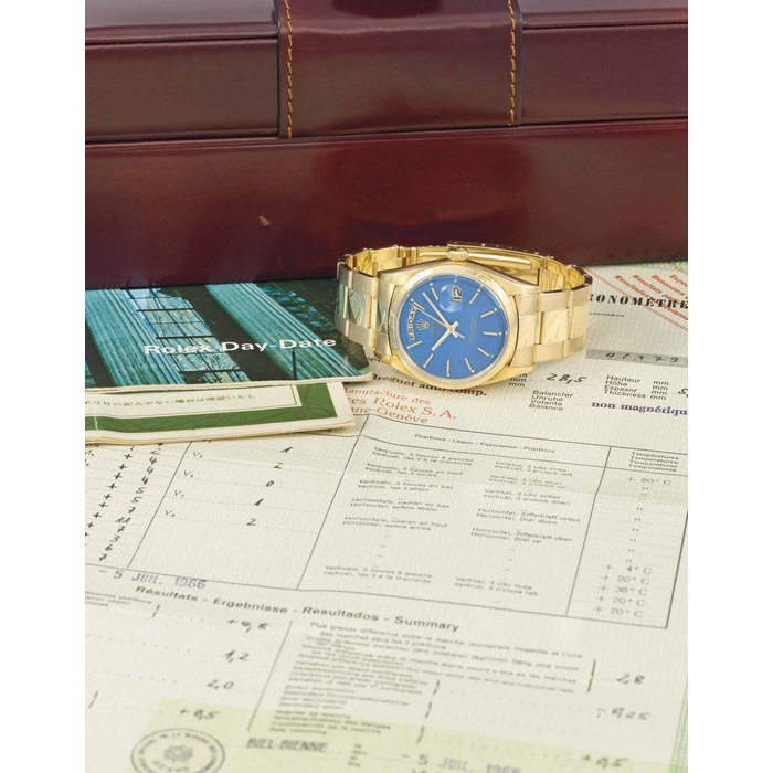 Rolex. A very fine, rare and attractive 18K gold automatic calendar wristwatch with blue lacquered dial, bracelet and Watch Rate Certificate SIGNED ROLEX, OYSTER PERPETUAL, DAY-DATE, REF. 1803, CASE NO. 1'375'706, MOVEMENT NO. DD37951, MANUFACTURED IN 1966