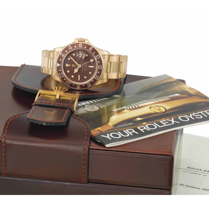 Rolex. A very fine, rare and attractive 18K gold automatic dual time wristwatch with sweep centre seconds, date and bracelet SIGNED ROLEX, OYSTER PERPETUAL, GMT-MASTER, RETAILED BY TIFFANY & CO., REF. 1675, CASE NO. 1'810'289, CIRCA 1968