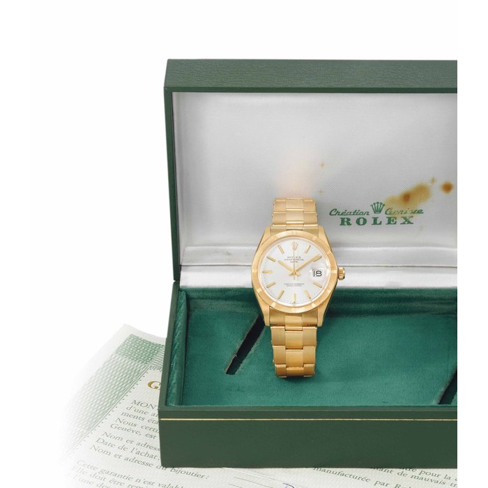 Rolex. A fine and attractive 18K gold automatic wristwatch with date, sweep centre seconds, bracelet, original Guarantee and box SIGNED ROLEX, OYSTER PERPETUAL, DATE, REF. 1501, CASE NO. 4'062'828, CIRCA 1975
