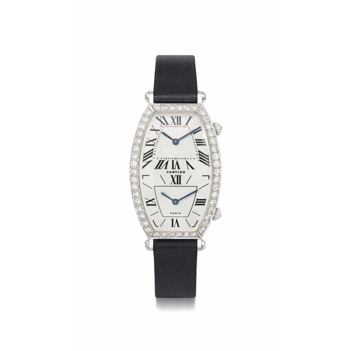Cartier. A lady's fine and elegant 18K white gold and diamond-set large tonneau-shaped dual time quartz wristwatch SIGNED CARTIER, PARIS, TONNEAU MODEL, CASE NO. A114837, CIRCA 2000