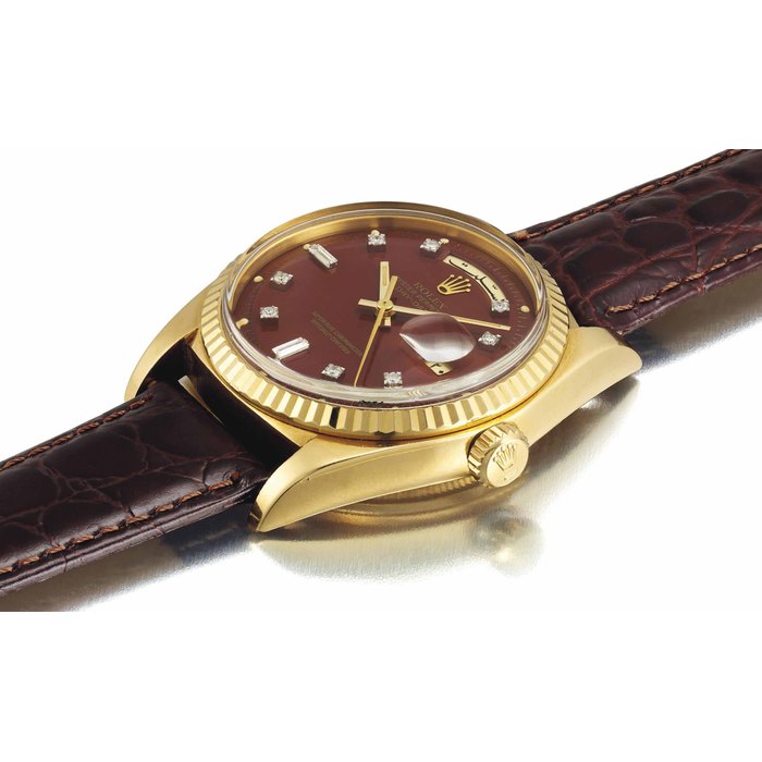 Rolex. A fine and very rare 18K gold and diamond-set automatic wristwatch with sweep centre seconds, burgundy lacquer dial and Arabic calendar indication, made for the Sultanate of Oman SIGNED ROLEX, OYSTER PERPETUAL DAY-DATE, RETAILED BY ASPREY, REF. 1803, CASE NO. 3'680'000, MANUFACTURED IN 1974