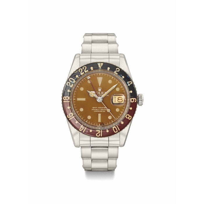 Rolex. A very fine and highly attractive stainless steel automatic dual time wristwatch with sweep centre seconds, alternate red and black date, tropical dial, bakelite bezel, bracelet and original Guarantee SIGNED ROLEX, OYSTER PERPETUAL, GMT-MASTER MODEL, REF. 6542, CASE NO. 397'903, CIRCA 1958