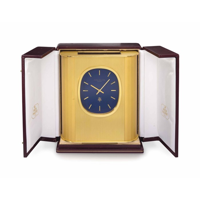 Patek Philippe. A gilt brass rectangular solar-powered desk clock SIGNED PATEK PHILIPPE, GENÈVE, GOLDEN ELLIPSE MODEL, CIRCA 1985
