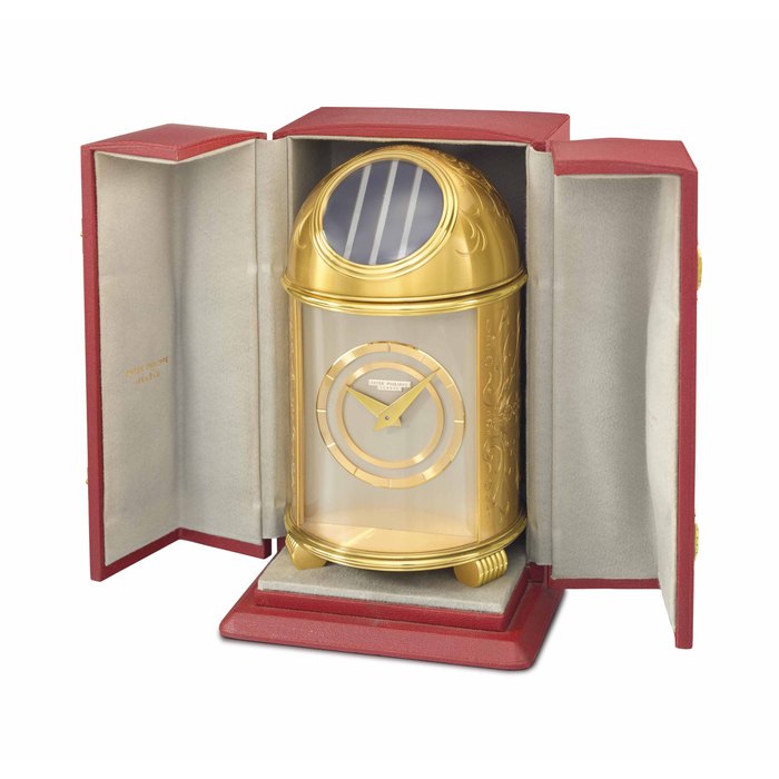 Patek Philippe. A fine gilt brass solar-powered dome table clock and presentation box SIGNED PATEK PHILIPPE, GENÈVE, REF. 718, MOVEMENT NO. 872'530, MANUFACTURED IN 1953