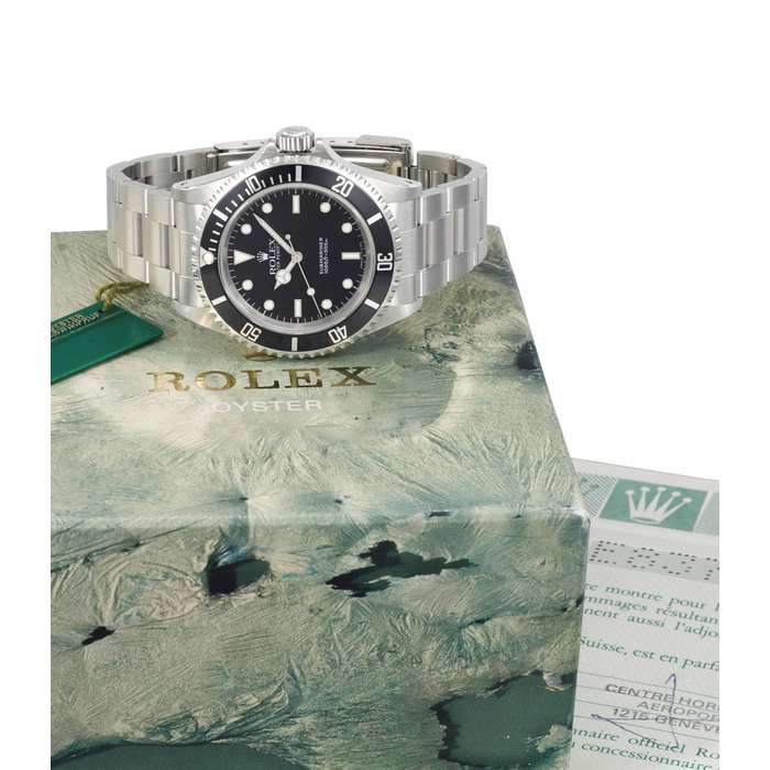 Rolex. A stainless steel automatic wristwatch with sweep centre seconds, bracelet, guarantee, sales tag and box SIGNED ROLEX, OYSTER PERPETUAL, SUBMARINER, 1000FT=300M, REF. 14060, CASE NO. E837797, MANUFACTURED IN 1991