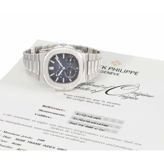 Patek Philippe. A large stainless steel automatic wristwatch with date, power reserve, moon phases, bracelet, Guarantee and box SIGNED PATEK PHILIPPE, GENEVE, NAUTILUS MODEL, REF. 5712/1A, MOVEMENT NO. 3'179'310, CASE NO. 4'419'196, MANUFACTURED IN 2009