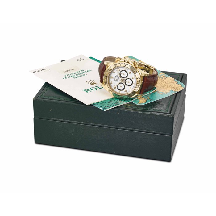Rolex. An 18K gold automatic chronograph wristwatch with Garantie and box SIGNED ROLEX, OYSTER PERPETUAL COSMOGRAPH, DAYTONA, REF. 16518, MOVEMENT NO. W763790, CIRCA 1996