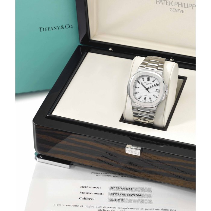 Patek Philippe. A fine and very rare stainless steel automatic bracelet watch with date, sweep centre seconds, white dial, Certificate and box SIGNED PATEK PHILIPPE, GENEVE, RETAILED BY TIFFANY & CO., NAUTILUS MODEL, REF. 5711/1A-011, MOVEMENT NO. 5'773'375, CASE NO. 4'675'104, CIRCA 2013