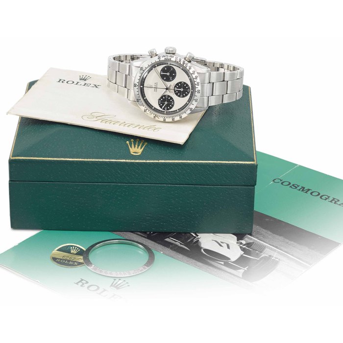 Rolex. A very fine and rare stainless steel chronograph wristwatch with Paul Newman dial, bracelet, green sticker, second bezel, blank Guarantee, brochure and box Signed Rolex, Cosmograph, Daytona, Paul Newman model, ref. 6262, case no. 2’413’933, circa 1970